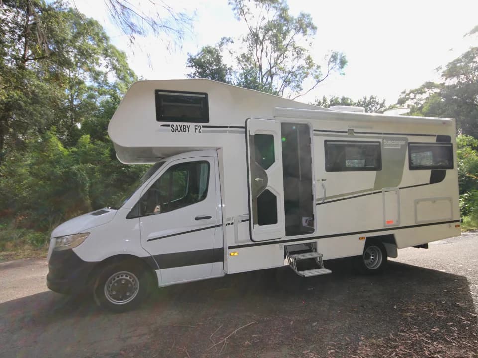 Saxby F-2 entry door open with dual electric steps deployed, passenger side