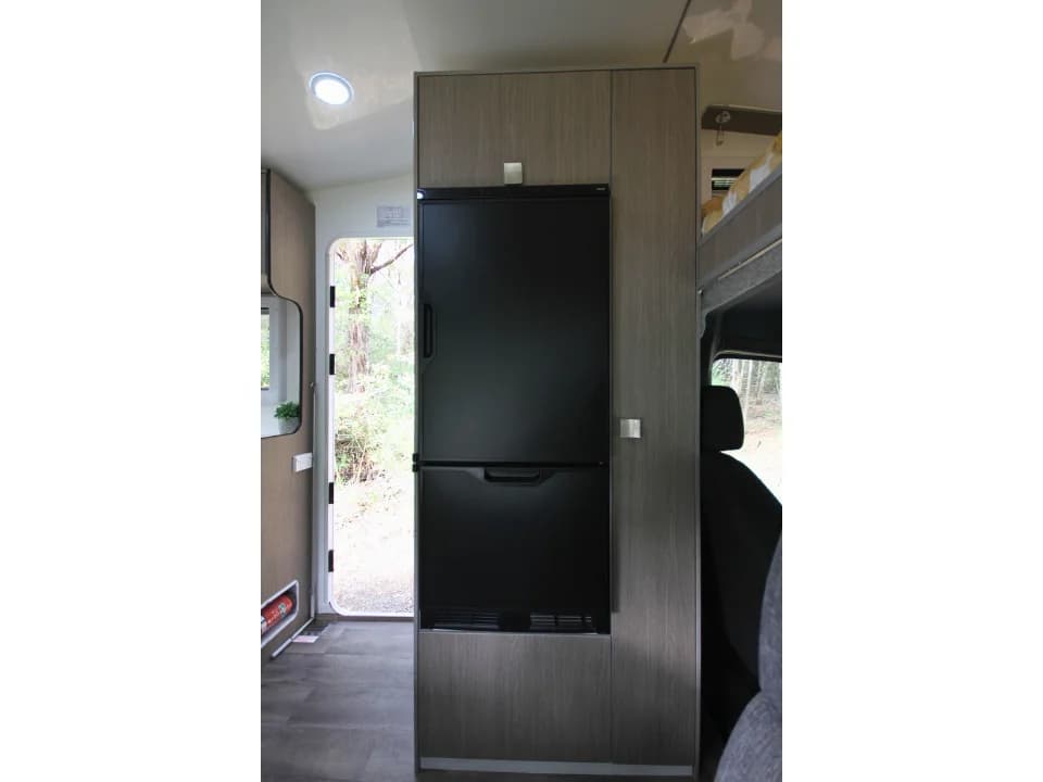 Saxby F-2 interior — 174L Thetford 12V compressor fridge in full-height cabinetry
