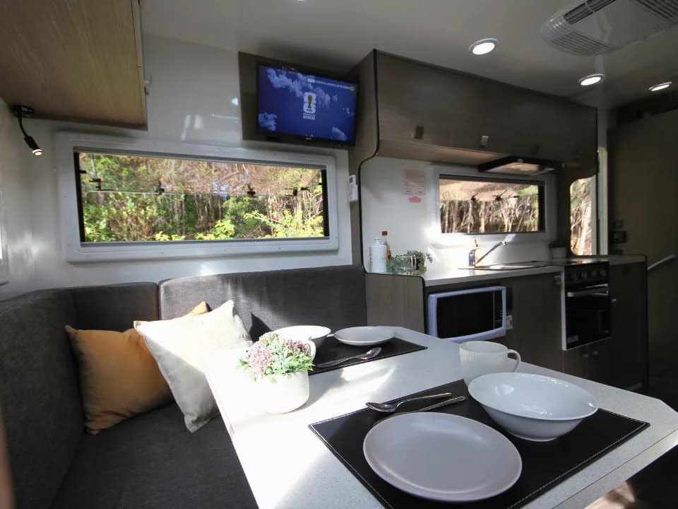 Saxby F-2 interior — club lounge table setting with kitchen visible in background