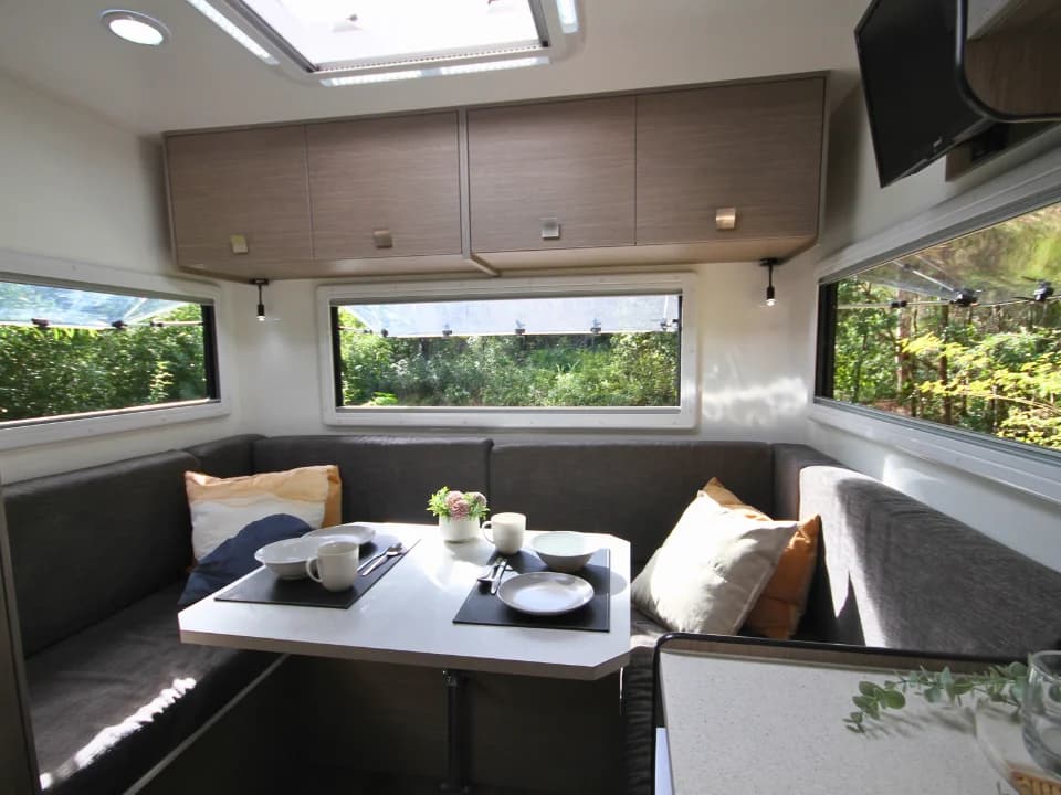 Saxby F-2 interior — rear club lounge with panoramic windows, overhead skylight and smart TV