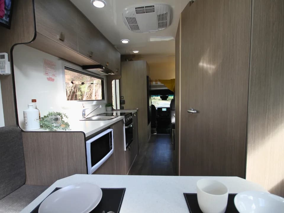 Saxby F-2 interior — kitchen, microwave and walkthrough corridor toward cab