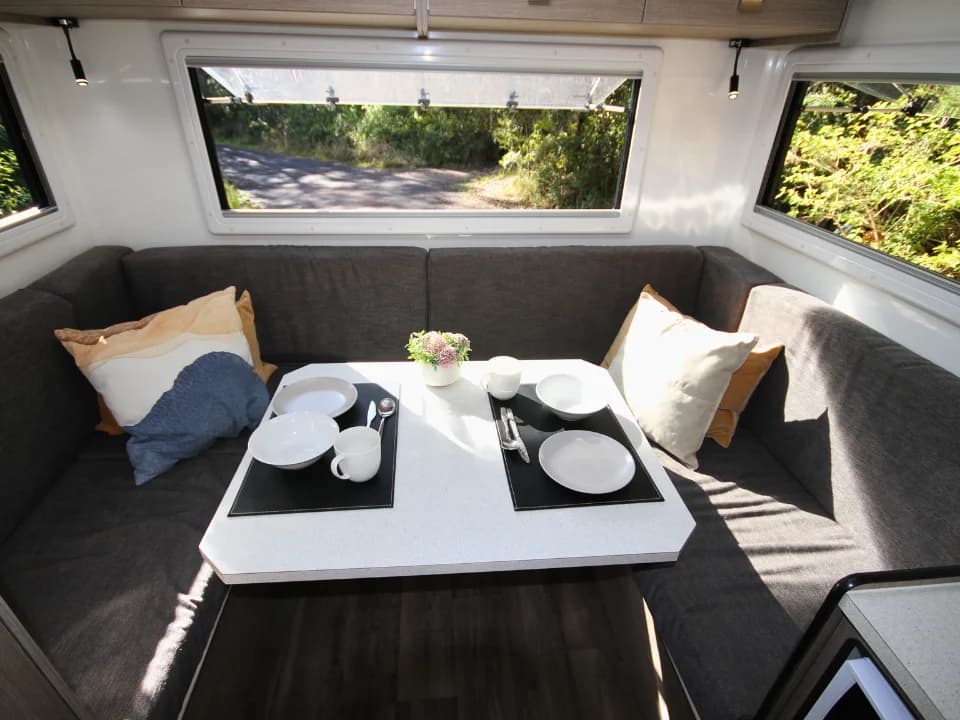 Saxby F-2 demo interior — rear lounge wide angle with table setting and panoramic windows