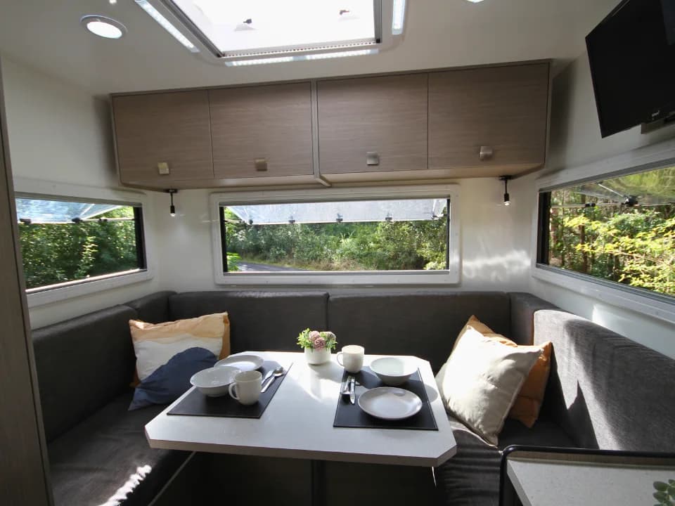 Saxby F-2 demo interior — rear club lounge with panoramic windows, overhead skylight and smart TV