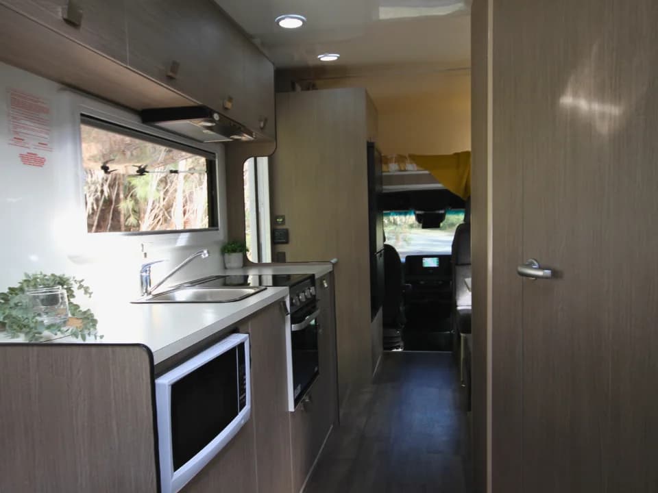 Saxby F-2 demo interior — kitchen and walkthrough corridor looking toward cab