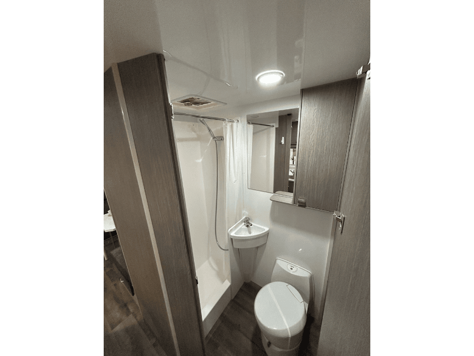 2024 Saxby F-2 demo interior — separate bathroom with shower and cassette toilet