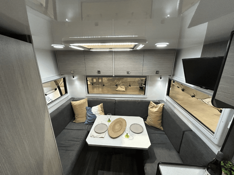 2024 Saxby F-2 demo interior — dinette seating and rear lounge area