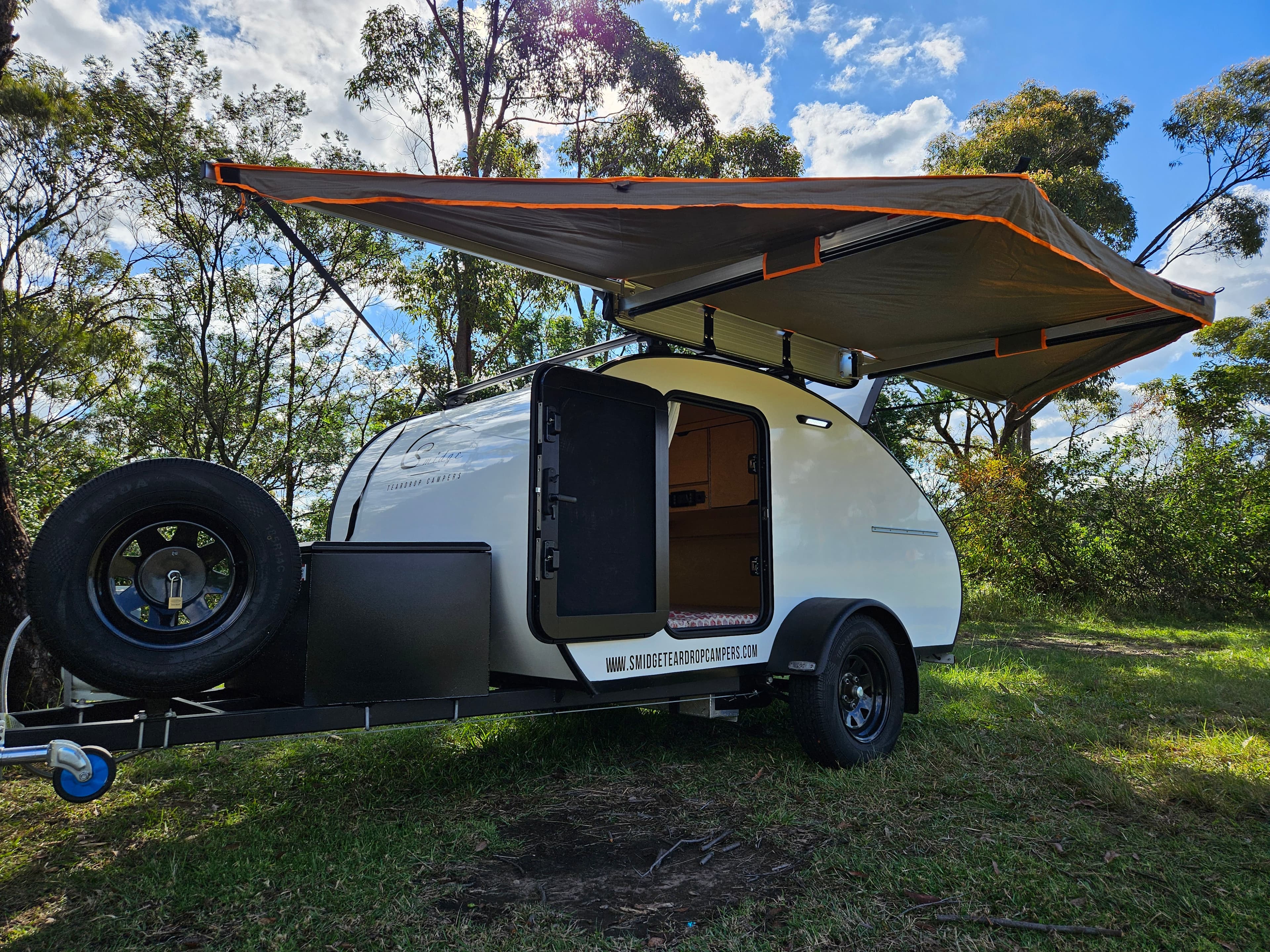 2024 Smidge Breeze — 180° wrap-around awning fully deployed, entry door open