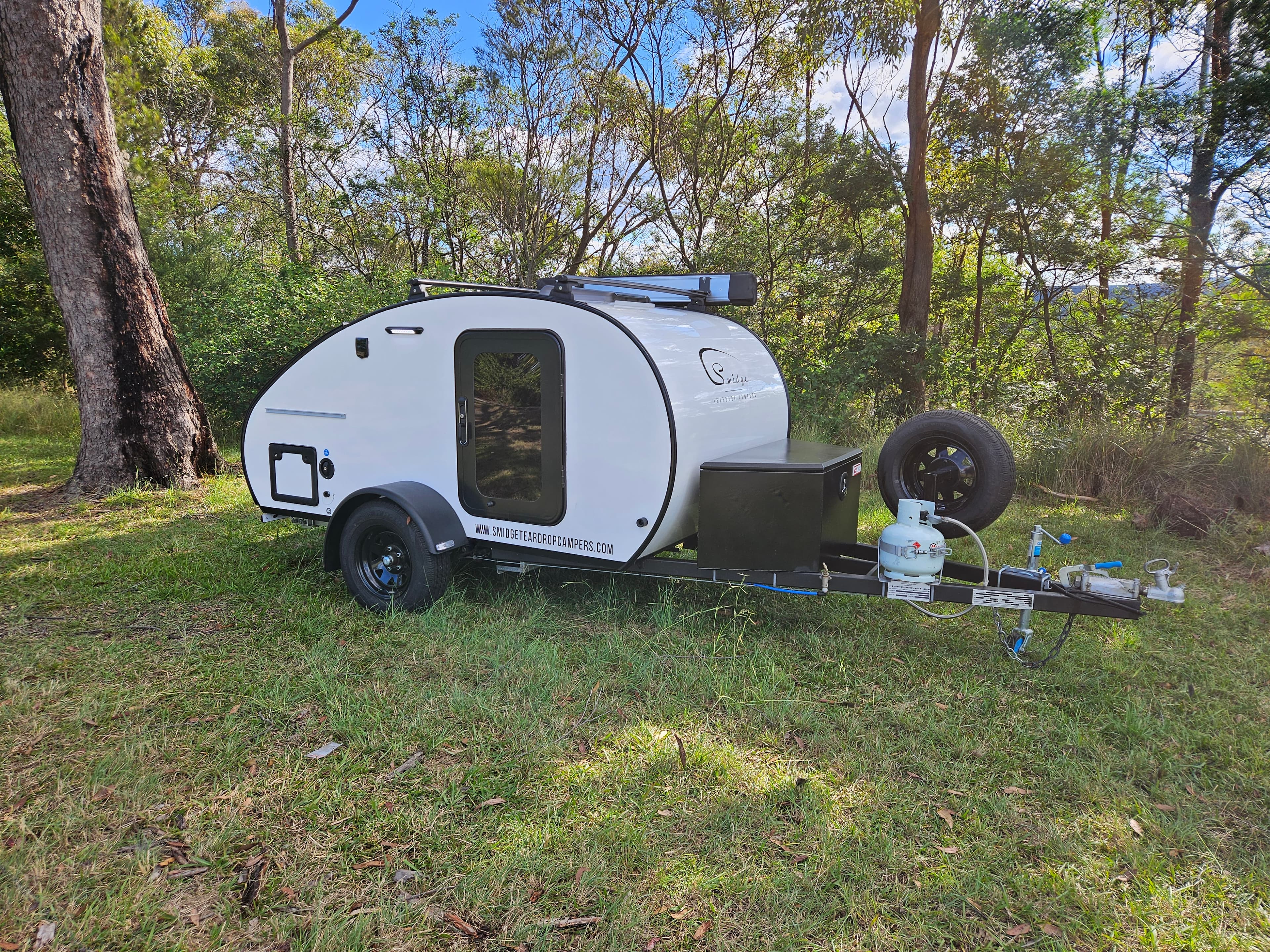 2024 Smidge Breeze — rear three-quarter view, drawbar toolbox and spare wheel visible