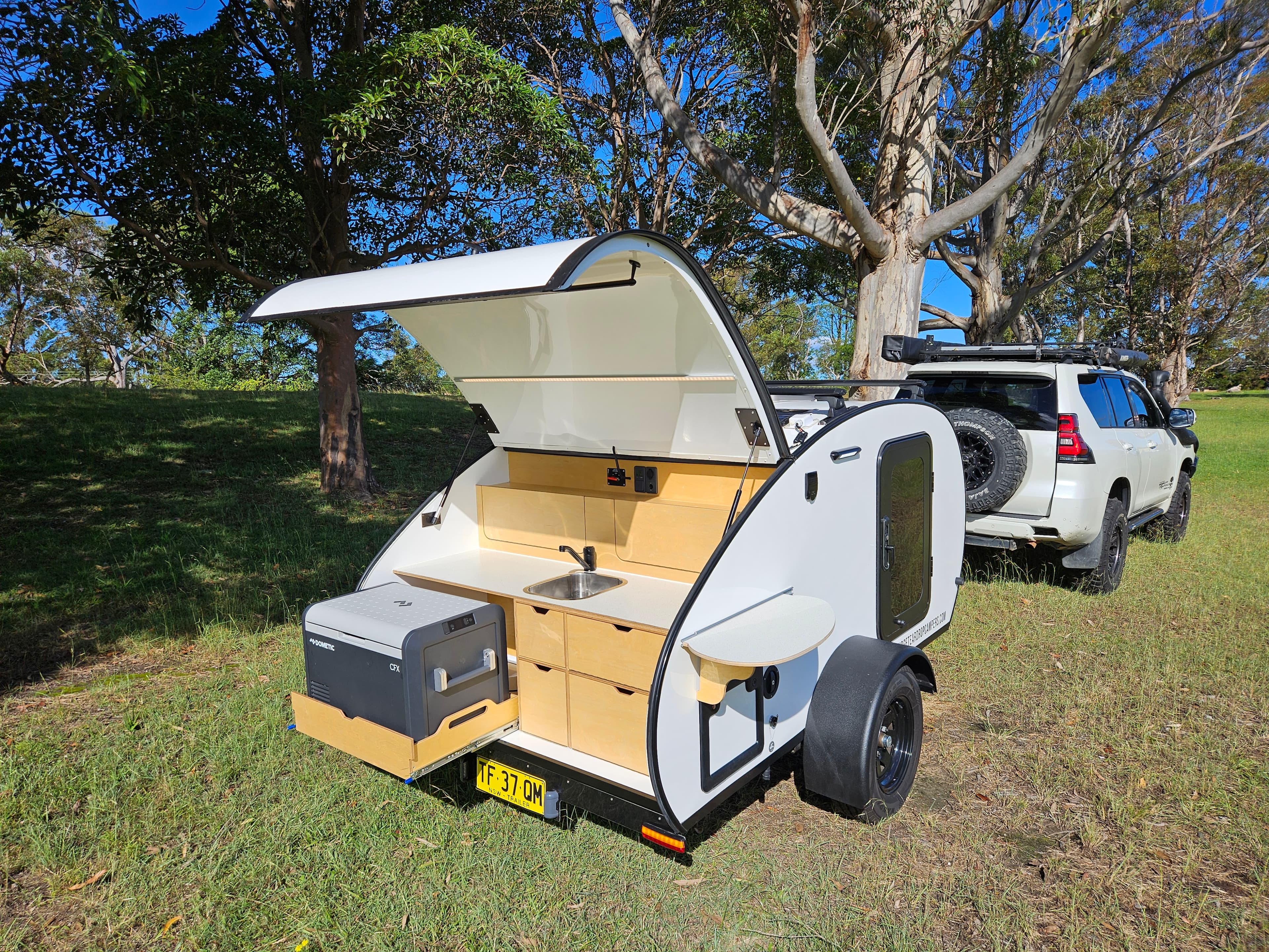 2024 Smidge Breeze — galley open showing slide-out 55L compressor fridge