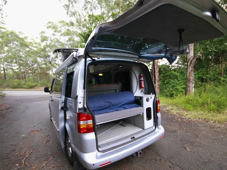 2007 Trakka Trakkadu T5 campervan — rear tailgate open showing the rear bed, storage and fire extinguisher