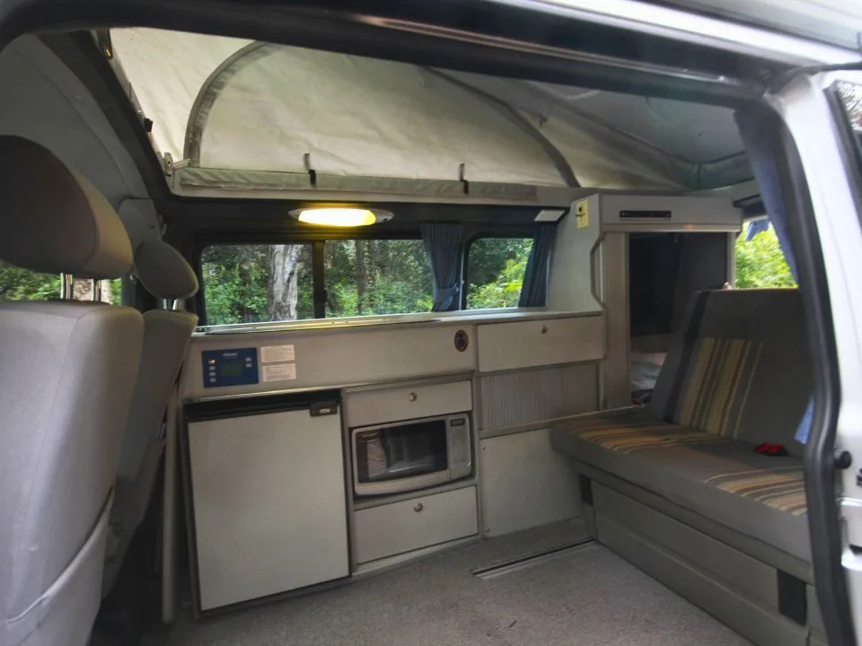 2007 Trakka Trakkadu T5 campervan — interior viewed through the sliding side door with pop-top headroom