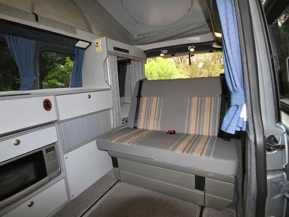 2007 Trakka Trakkadu T5 campervan — interior living area with swivel seats and dining table