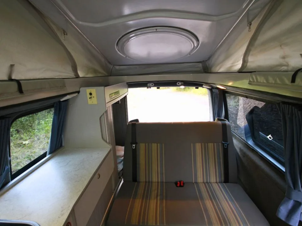 2007 Trakka Trakkadu T5 campervan — interior looking toward the rear living area and bench seat