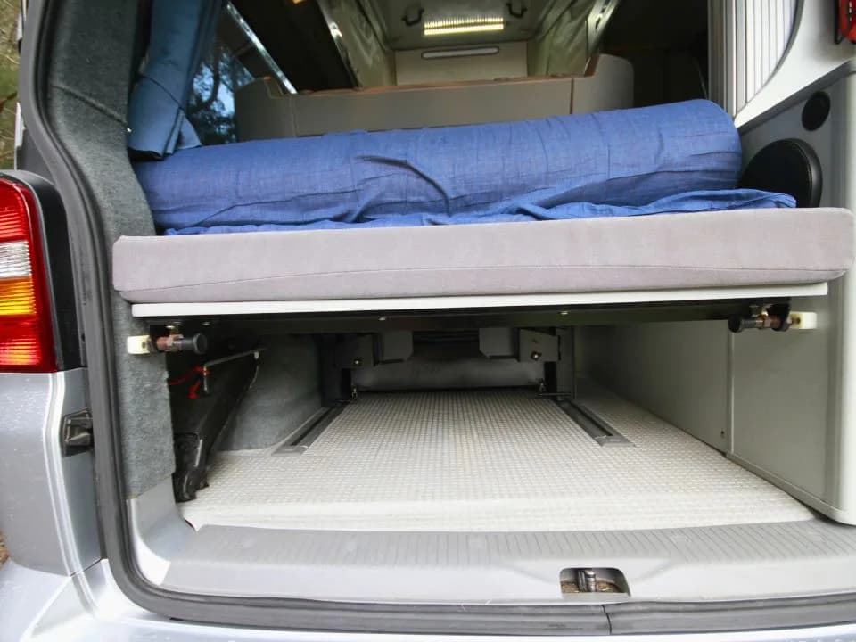 2007 Trakka Trakkadu T5 campervan — rear bench seat made up with cushions, viewed from the tailgate