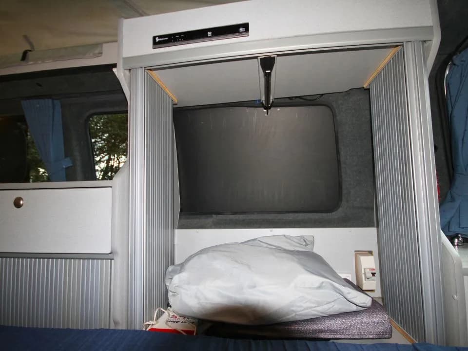 2007 Trakka Trakkadu T5 campervan — rear sleeping area showing the bed base and storage