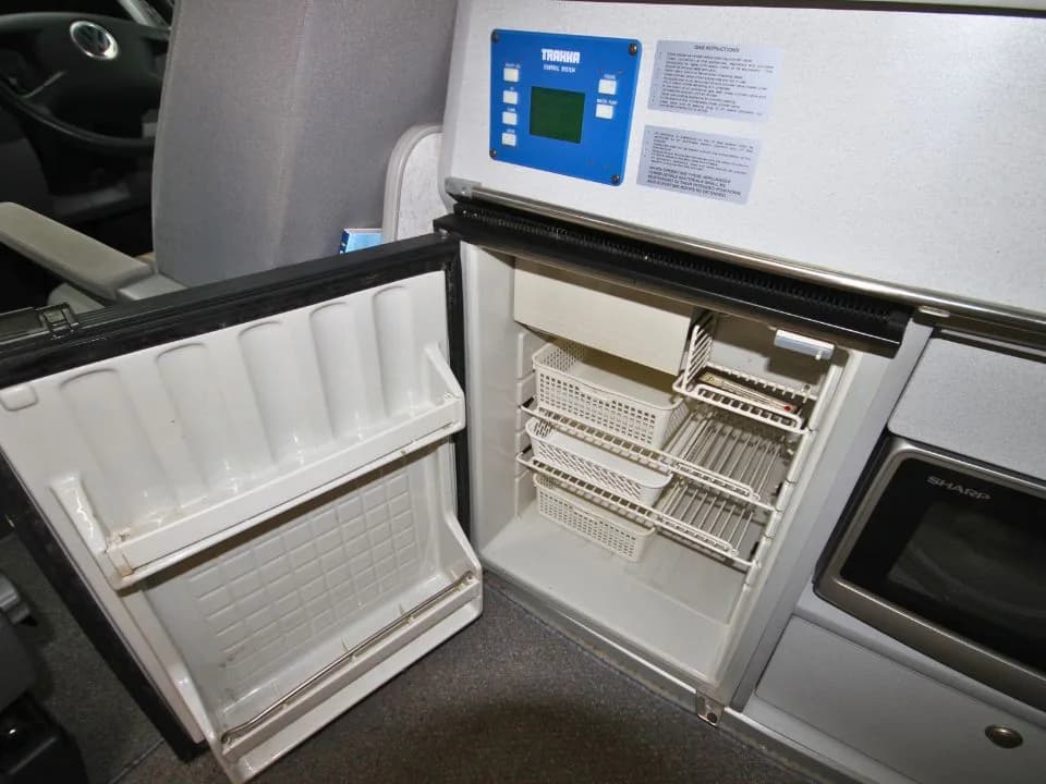 2007 Trakka Trakkadu T5 campervan — roller-shutter cabinet open showing interior storage