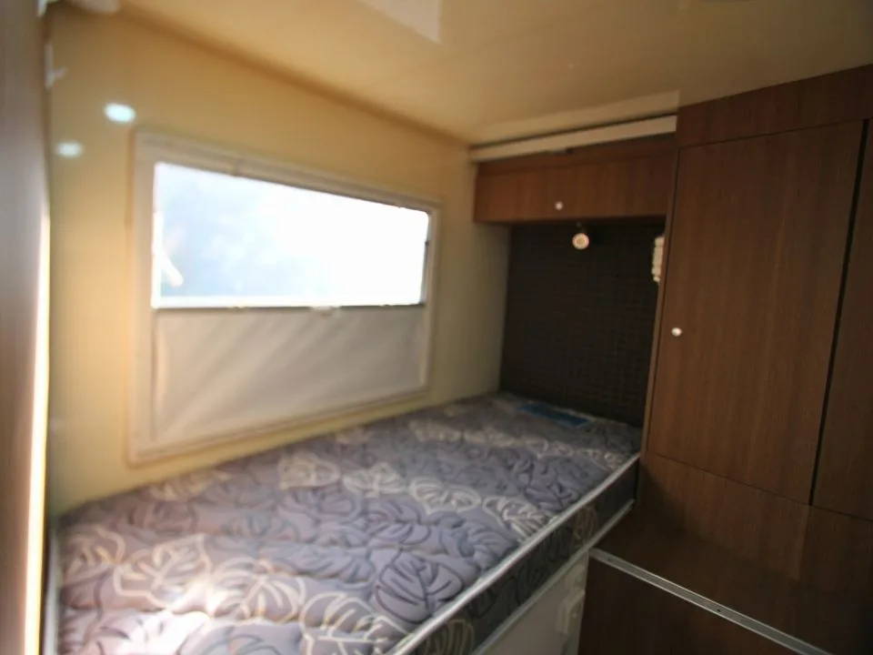 2011 Suncamper Sydney motorhome — interior single bed with overhead storage and window