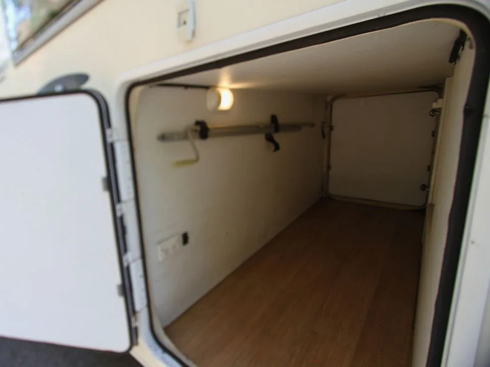 2011 Suncamper Sydney motorhome — large rear underfloor garage storage compartment open
