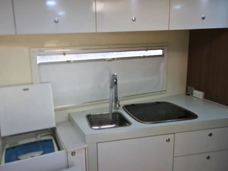 2011 Suncamper Sydney motorhome — interior kitchen with cutlery drawer open