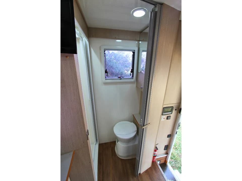 2015 Suncamper Sherwood 4x4 Twin motorhome — interior bathroom with cassette toilet and mirror