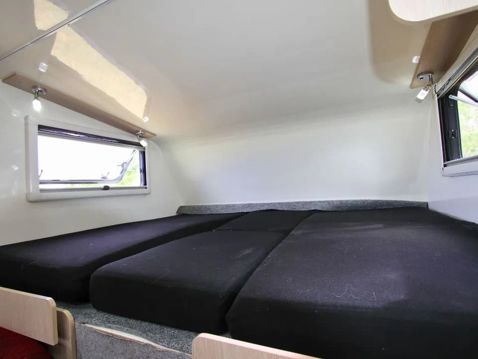 2015 Suncamper Sherwood 4x4 Twin motorhome — interior over-cab twin beds, close detail