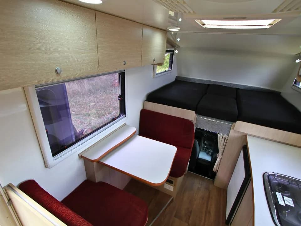 2015 Suncamper Sherwood 4x4 Twin motorhome — interior dinette with table down