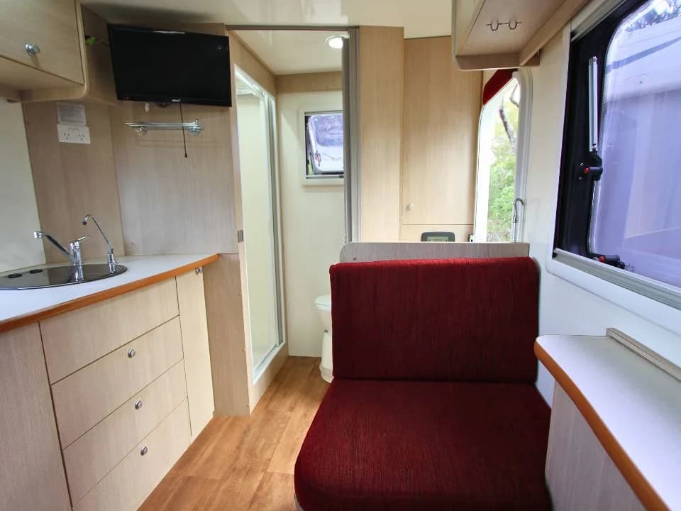 2015 Suncamper Sherwood 4x4 Twin motorhome — interior kitchen sink with bathroom door open