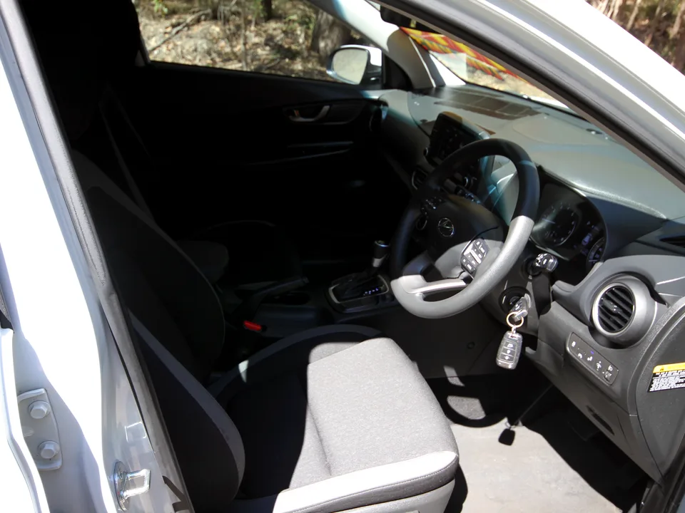 2019 Hyundai Kona Go interior — wide cabin view from open driver's door