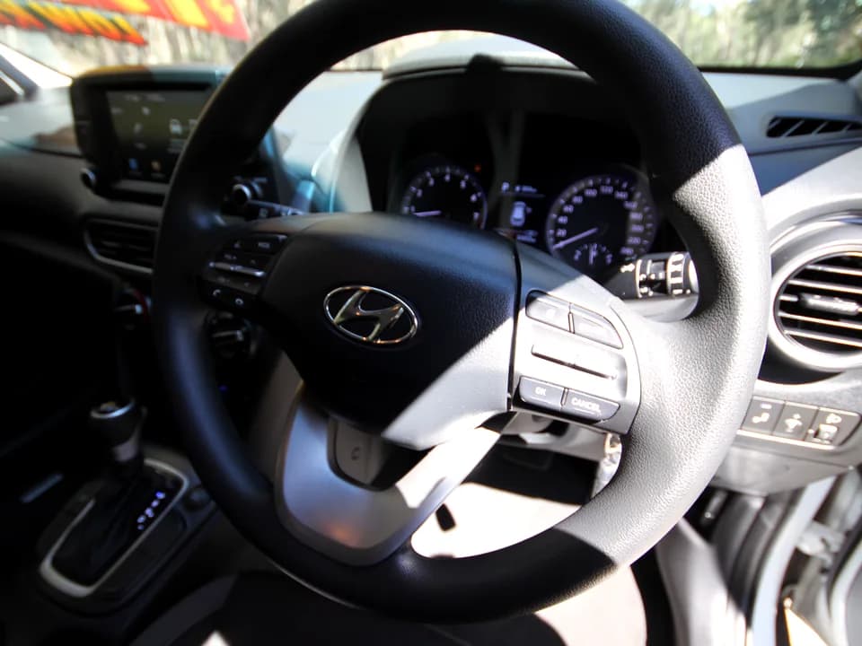 2019 Hyundai Kona Go interior — steering wheel and Hyundai badge close-up
