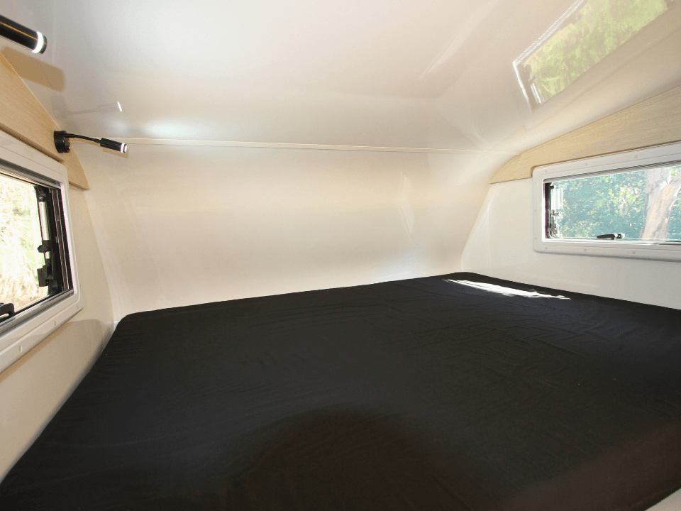 2024 Suncamper Sherwood E-2 interior — over-cab bed, full width view