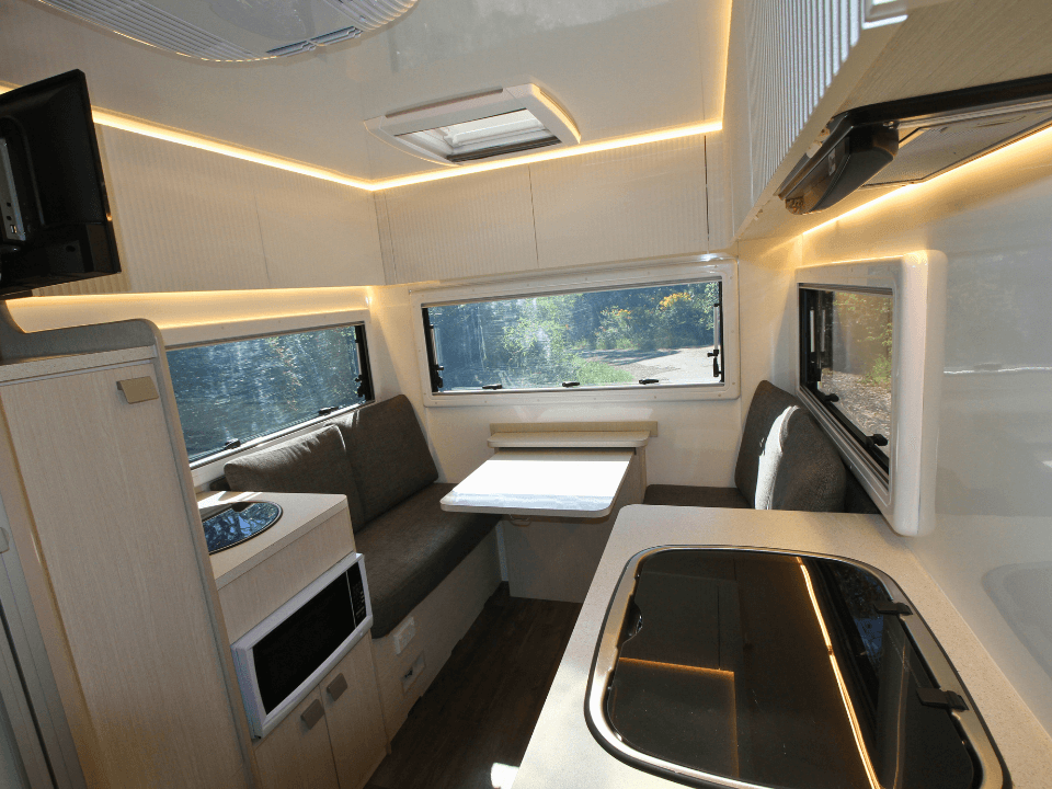 2024 Suncamper Sherwood E-2 interior — lounge and dinette with fold-out table
