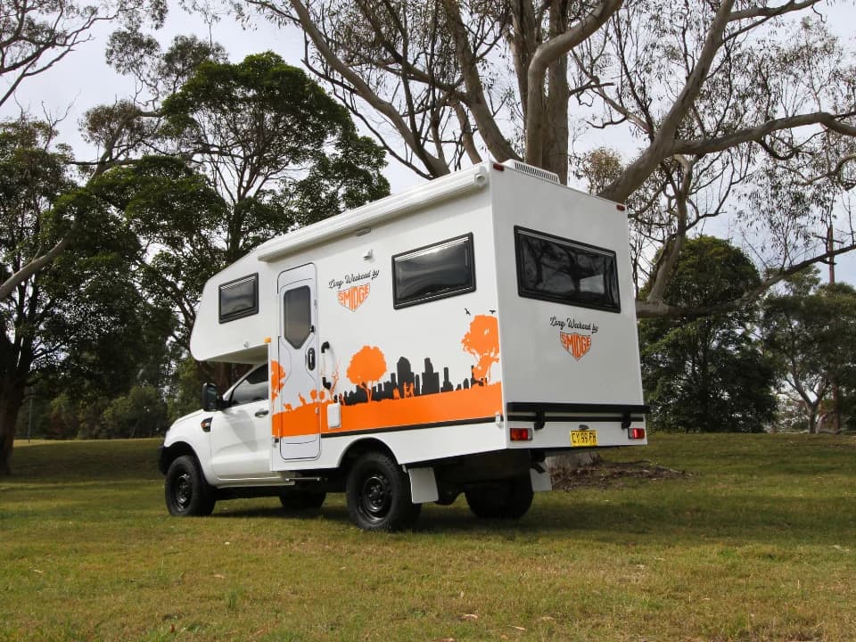 2026 Made by Smidge Long Weekend compact 4x4 motorhome — exterior rear three-quarter view showing the full body on a Toyota HiLux or Ford Ranger chassis
